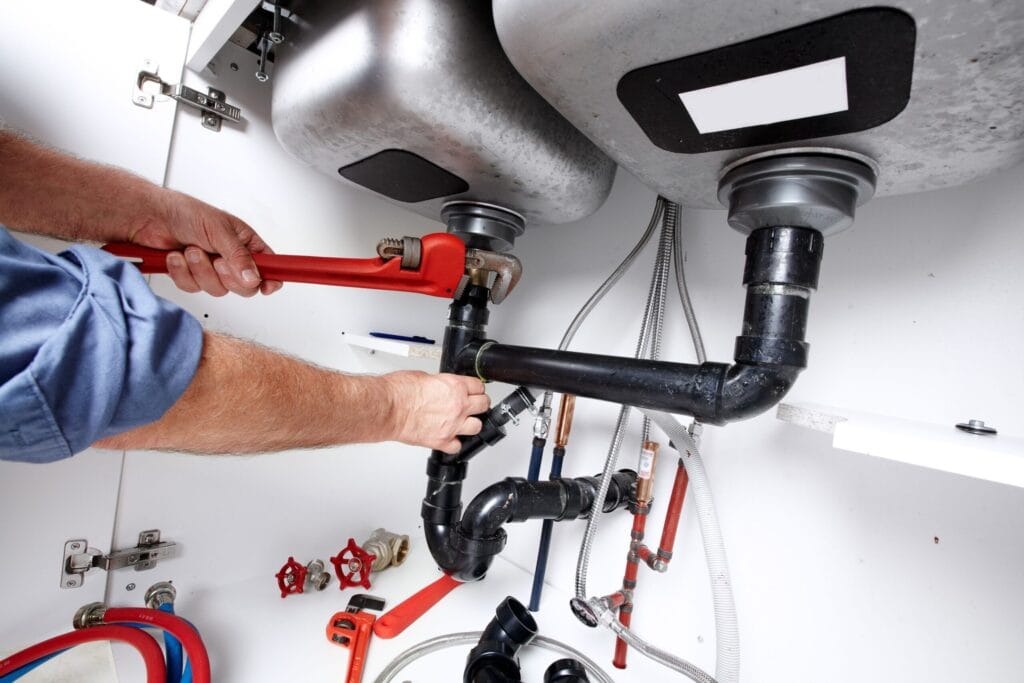 Duluth Plumbing Pros fixing under sink plumbing and drain pipes