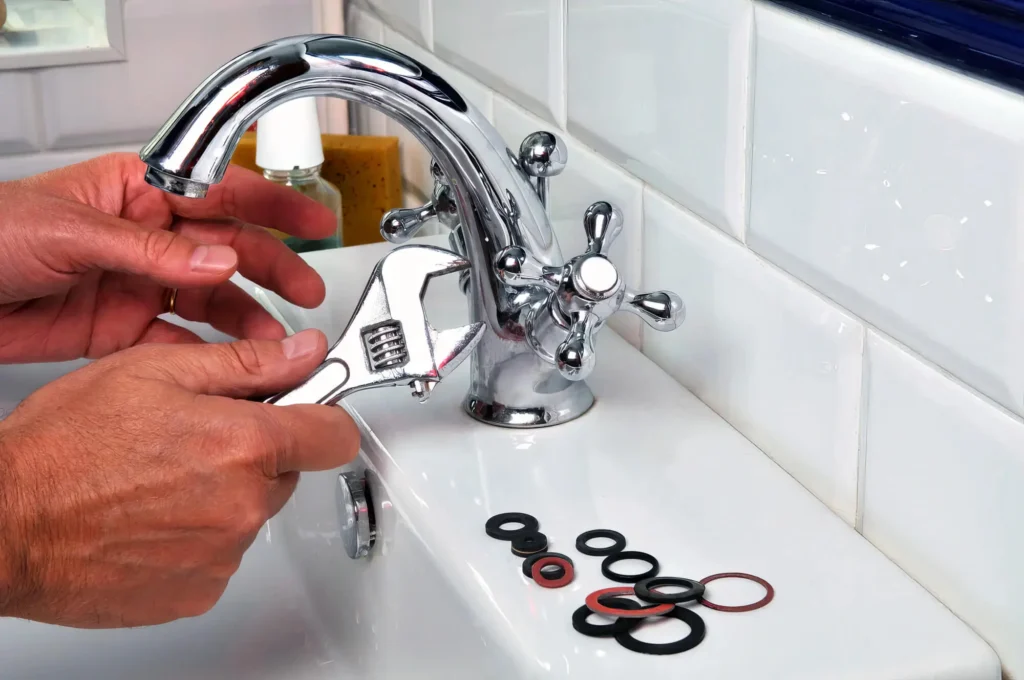 Plumber performing maintenance on a bathroom faucet in Duluth