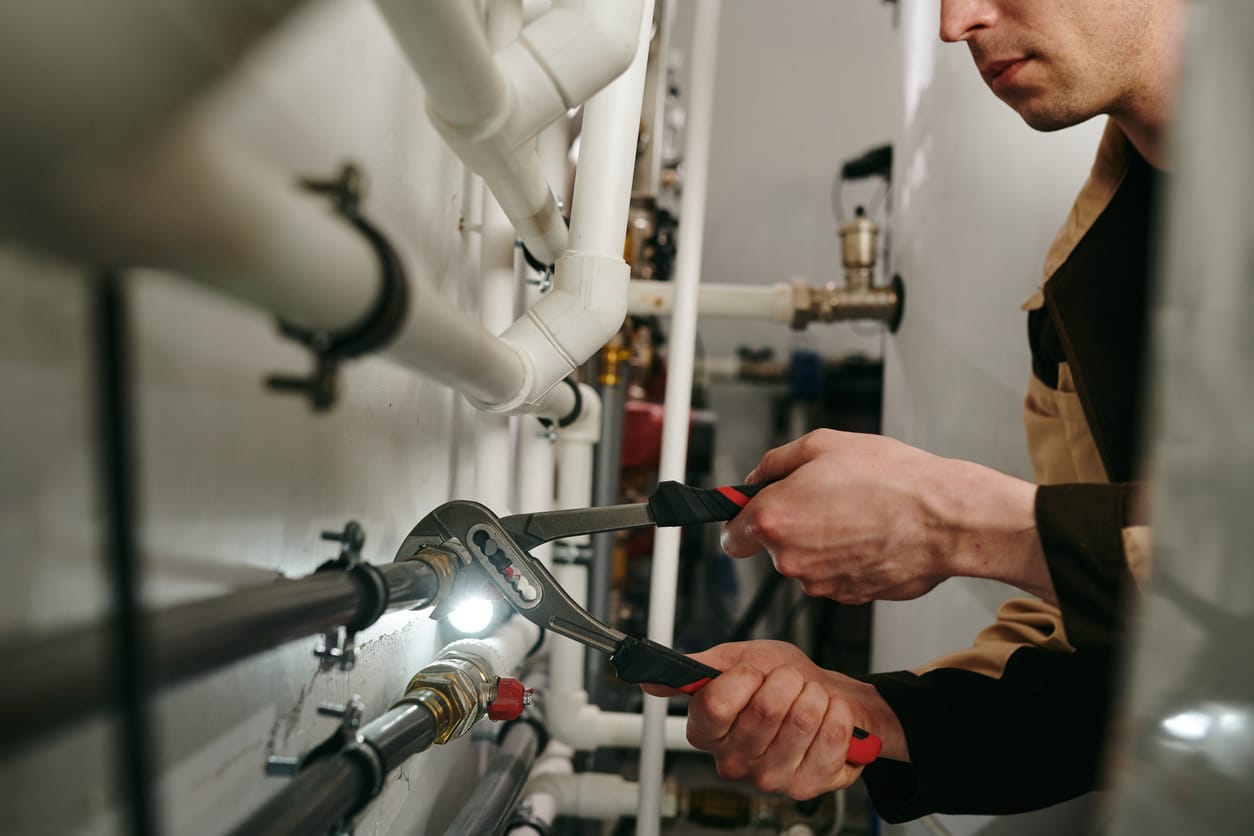 Plumbers maintaining commercial plumbing pipes in Duluth