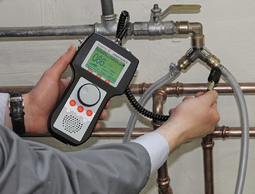 Plumber testing pipes with electronic leak detection equipment in Duluth