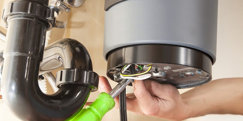 Technician repairing the heating element of a water heater in Duluth