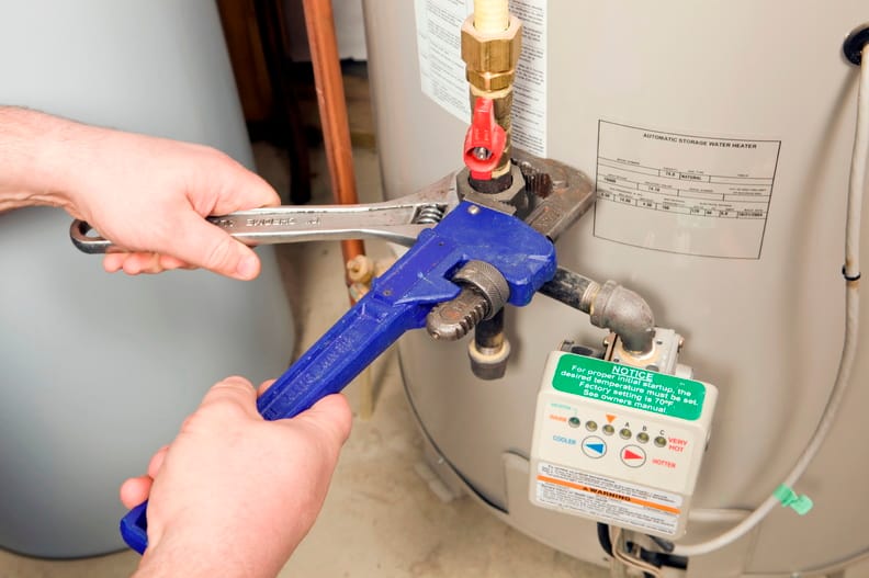 Plumber repairing a water heater valve in Duluth
